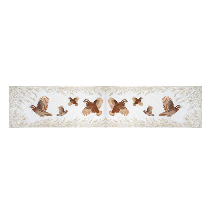 16x72 inch cream table runner featuring embroidered Bobwhite quail in flight and native grasses in rich earth tones.
