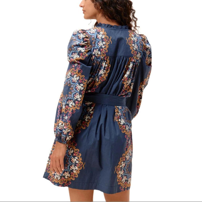 Cleobella Ivana organic cotton mini dress in navy with floral print, quilted sash waist, and long ruched sleeves.