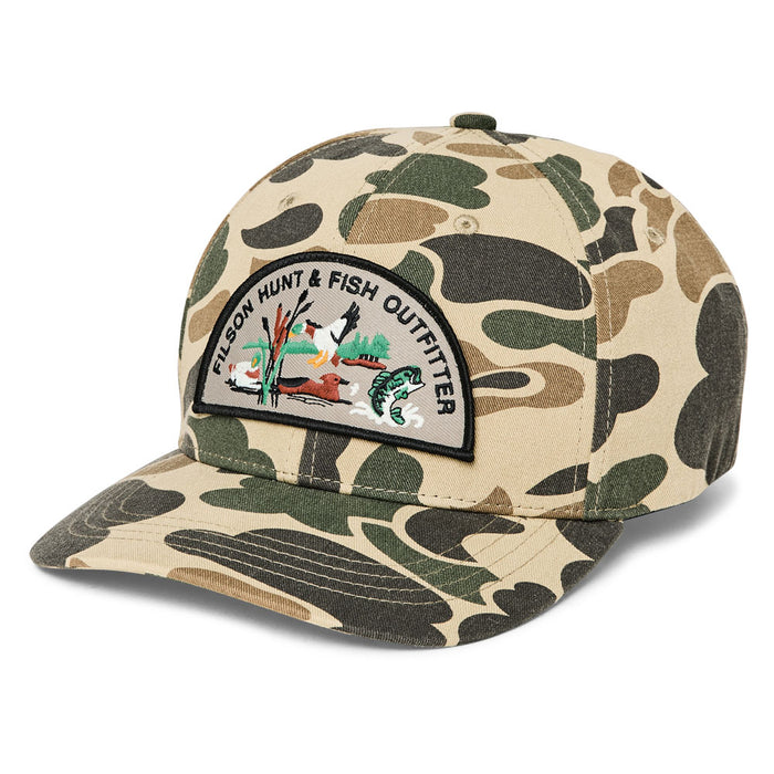 Filson Logger Cap in Hunt & Fish camo print cotton twill with a curved brim and embroidered outdoor graphic patch.