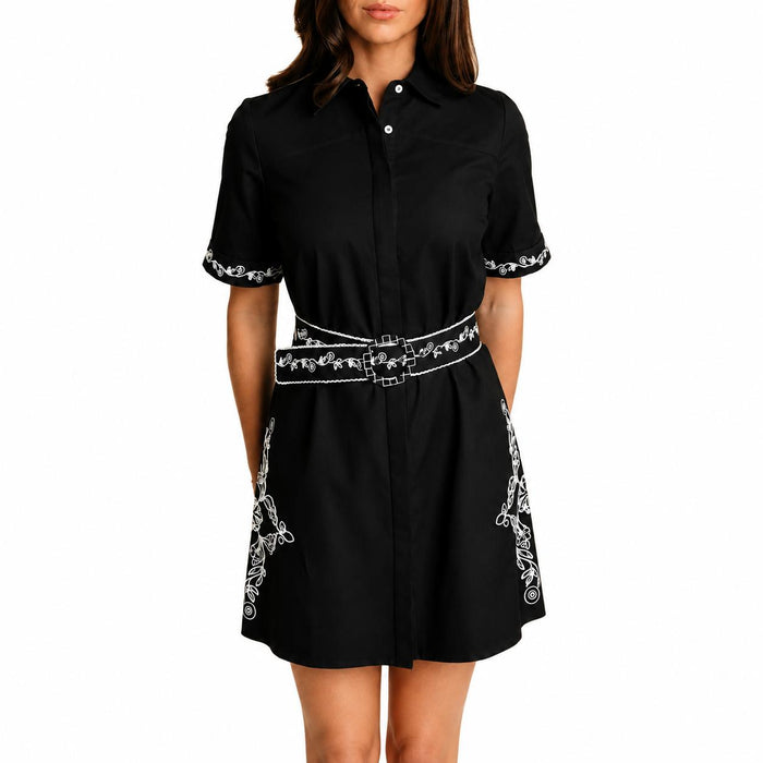 Black cotton LaRoque Demi dress with white embroidery on the cuffs, sides, and matching waist belt.
