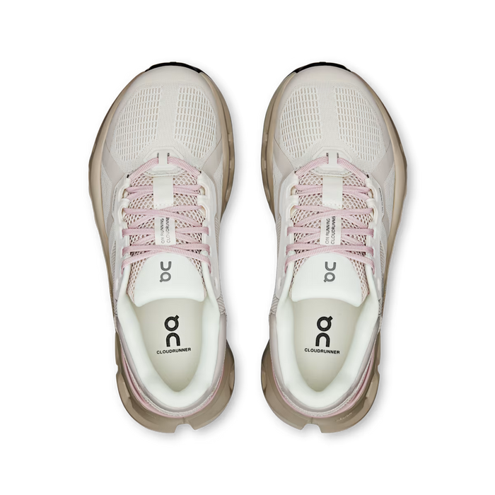 Top-down view of beige On Running Cloudrunner 2 women's shoes with pink laces and cushioned Helion foam midsoles.