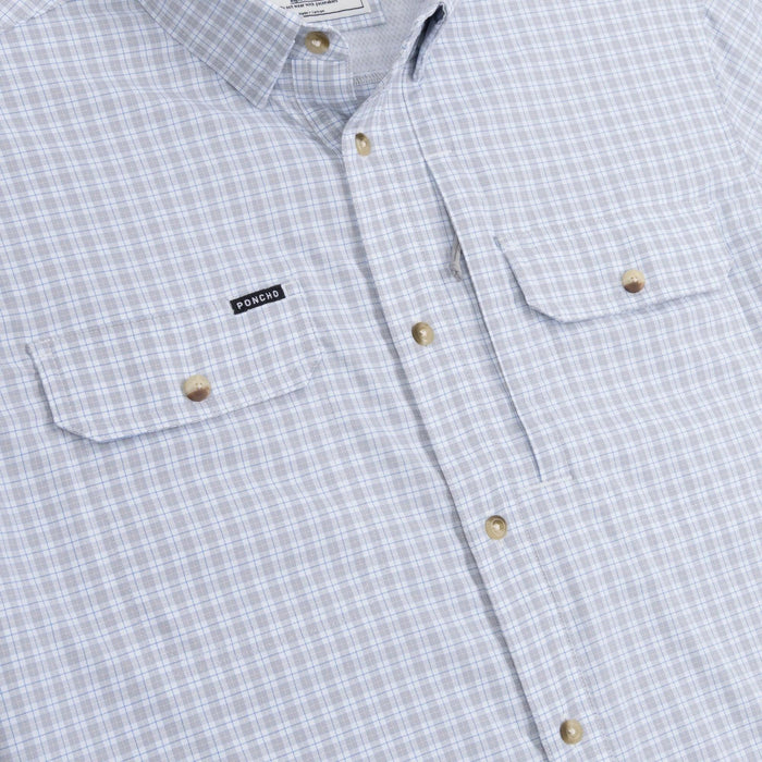 Light blue and white plaid short-sleeve performance shirt with button-down front and dual magnetic chest pockets.