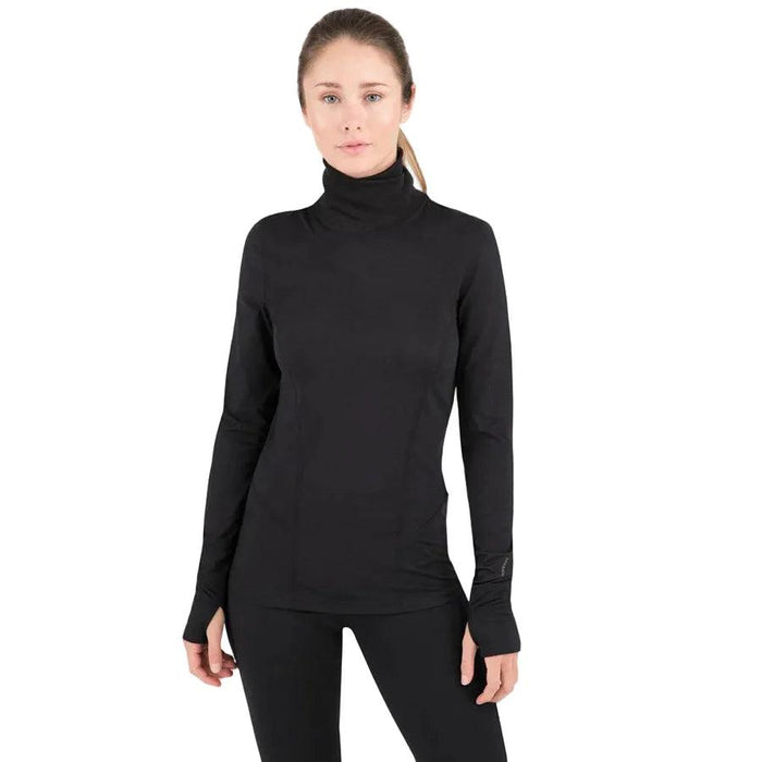 Woman wearing a black Terramar 2.0 Cloud Nine lightweight turtleneck base layer with long sleeves and thumbholes.