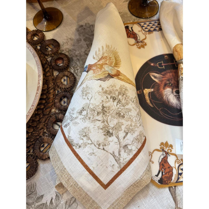 Cream-colored Italian linen napkins featuring intricate illustrations of gamebirds and foxes for elegant dining.