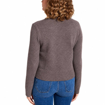 Back view of a brown 100% merino wool Eden turtleneck sweater with long sleeves and a ribbed hem, worn with blue jeans.