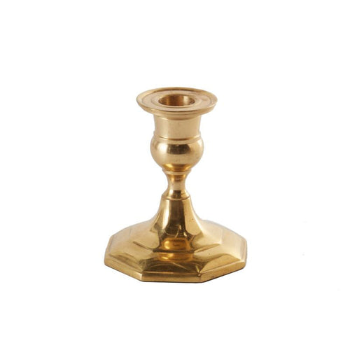 Antique gold metal taper candle holder with a classic slender stem and a sturdy octagonal base on a white background.