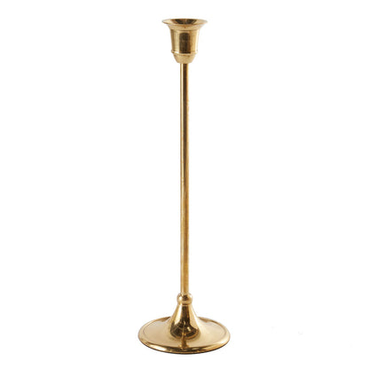 Tall antique gold metal taper candle holder with a slender stem and classic round base on a white background.