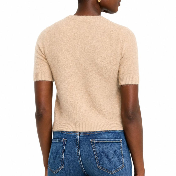 Beige 100% cashmere cropped short-sleeve crewneck sweater with ribbed trim, worn with blue jeans.