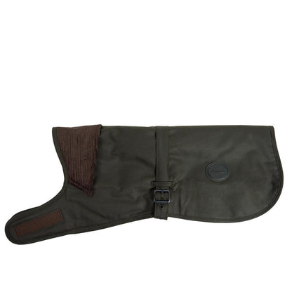 Olive green Barbour waxed cotton dog coat with a brown corduroy collar, adjustable buckle strap, and branded logo badge.