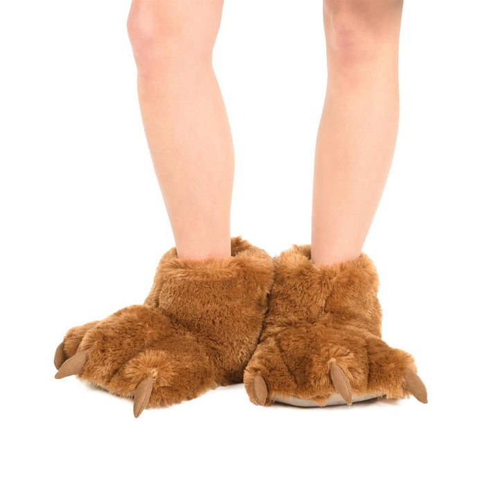 Brown faux-fur bear paw slippers with soft fleece lining and realistic claw details worn on feet.