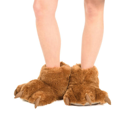 Brown faux-fur bear paw slippers with soft fleece lining and realistic claw details worn on feet.