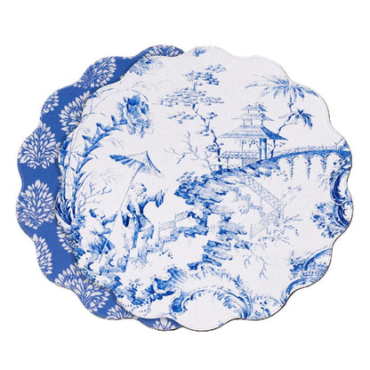 Reversible 15.5-inch round placemats featuring blue and white Chinoiserie pagoda scenes and floral patterns on linen-textured material.