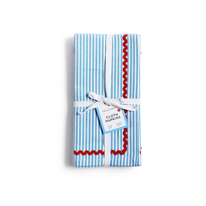 Set of four blue striped cotton dinner napkins tied with ribbon and featuring a decorative red ric rac trim.