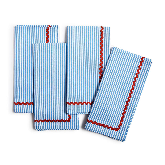 Set of four blue and white striped cotton dinner napkins featuring a decorative red ric rac trim.
