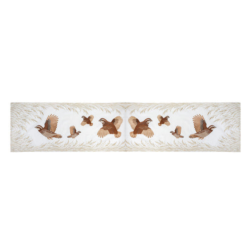 16x72 inch cream table runner featuring embroidered Bobwhite quail in flight and native grasses in rich earth tones.