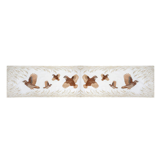 16x72 inch cream table runner featuring embroidered Bobwhite quail in flight and native grasses in rich earth tones.