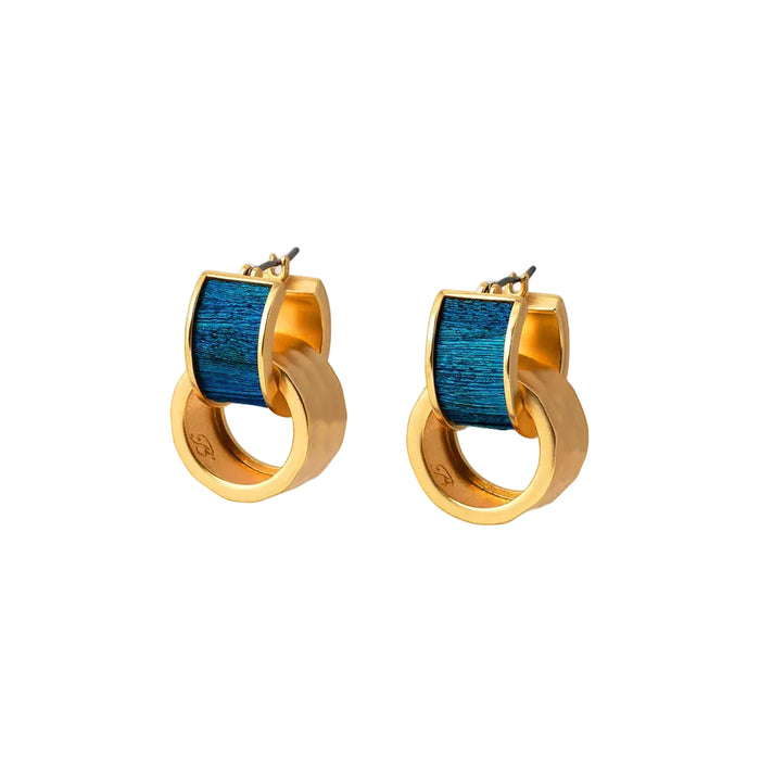 Brackish Eleuthera huggie hoop earrings featuring iridescent blue peacock feathers and removable hammered gold accents.