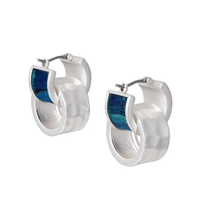 Silver huggie hoop earrings featuring iridescent blue and green peacock feathers and removable hammered silver accents.