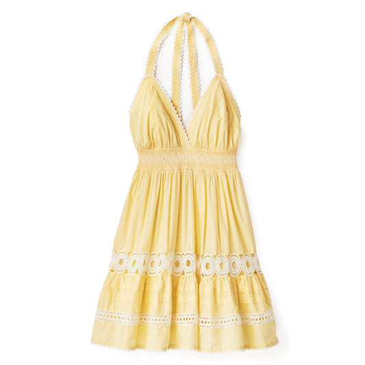 Yellow cotton voile mini dress with a smocked waist, halter neckline, and intricate white lace trim details.