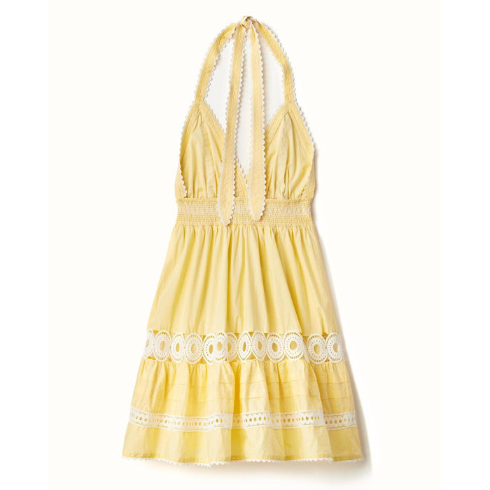 Yellow cotton voile mini dress with a smocked waist, halter neckline, and white lace trim details.