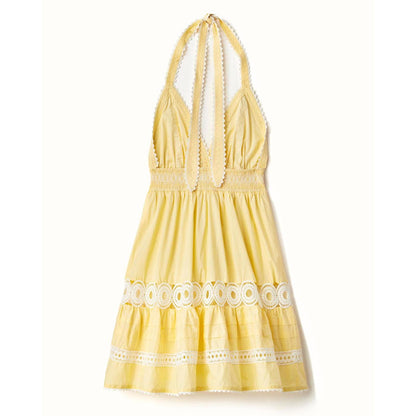 Yellow cotton voile mini dress with a smocked waist, halter neckline, and white lace trim details.