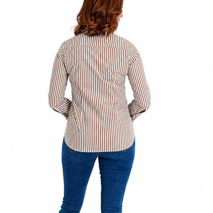 Woman wearing a long-sleeve taupe and white striped button-down shirt with a curved hem, paired with blue jeans.