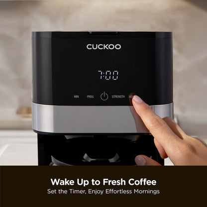 Close-up of a Cuckoo coffee maker, with the text: Wake Up to Fresh Coffee, Set the Timer, Enjoy Effortless Mornings. (CCM-BD011B)