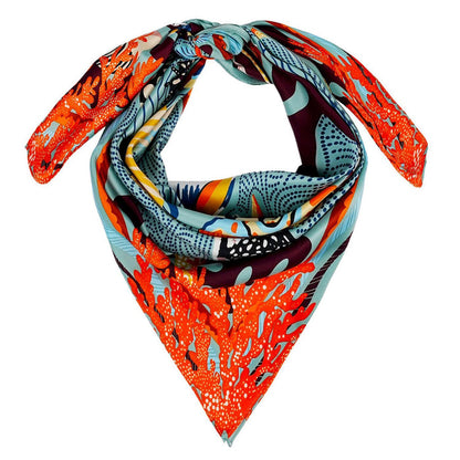 Square recycled polyester scarf featuring a vibrant coral and marine life print in blue, orange, and chocolate tones.