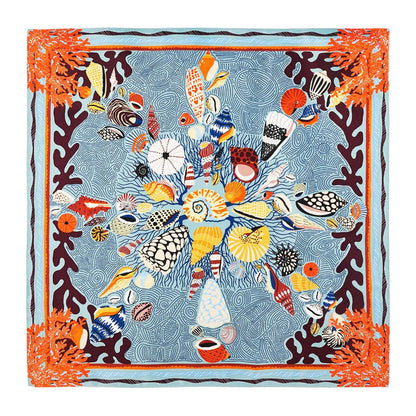 Square recycled polyester scarf featuring a coral and seashell print in blue, orange, and ochre on a navy background.
