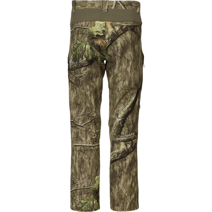 Drake Non-Typical hunting pants in camo print with a solid olive stretch waistband and durable polyester construction.