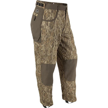 Drake Waterfowl MST camo wader pants with reinforced knees, adjustable waist, and stirrups for hunting comfort.