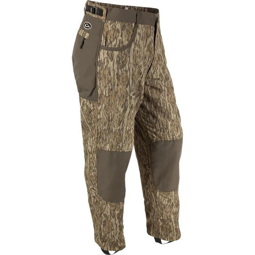 Drake Waterfowl MST camo wader pants with reinforced knees, adjustable waist, and stirrups for hunting comfort.