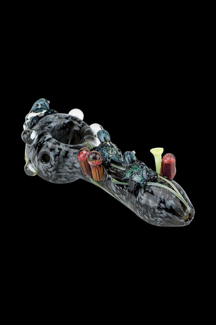 A side view of the Empire Glassworks Spoon Pipe - East Australian Current, showcasing its colorful, swirled glass design.