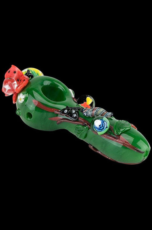 The Empire Glassworks Spoon Pipe - Garden Critters is shown in a side view, featuring colorful sculpted details resembling whimsical garden creatures.