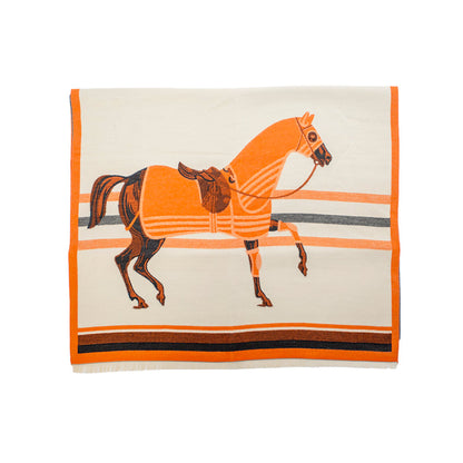 Cream-colored equestrian wrap featuring an orange horse motif, striped borders, and a soft, cashmere-like acrylic finish.