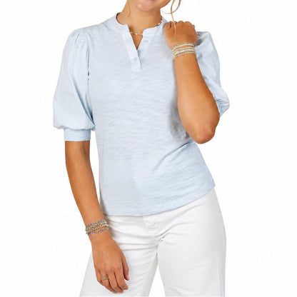 Light blue Erin Gray Kate top with puff sleeves, V-neckline, and soft Pima cotton bodice worn with white pants.
