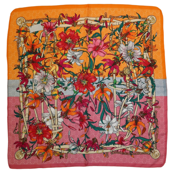 27-inch square polyester twill scarf featuring a vibrant floral lily print with orange and pink color-blocked borders.