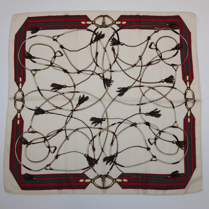 27-inch square polyester twill scarf with cream base, red and green striped borders, and an equestrian rope and tassel print.