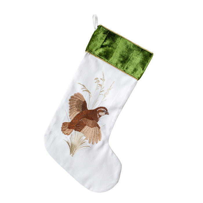 Cream cotton holiday stocking featuring an embroidered game bird and a forest green velvet cuff.
