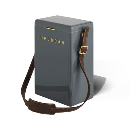 Grey FIELDBAR drinks box with an adjustable brown leather shoulder sling and gold hardware for hands-free carrying.