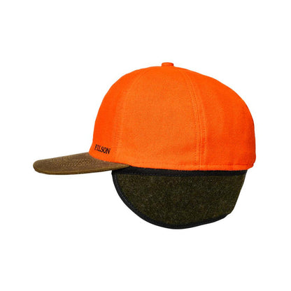 Filson blaze orange tin cloth cap with a brown brim and fold-down olive wool ear flaps.