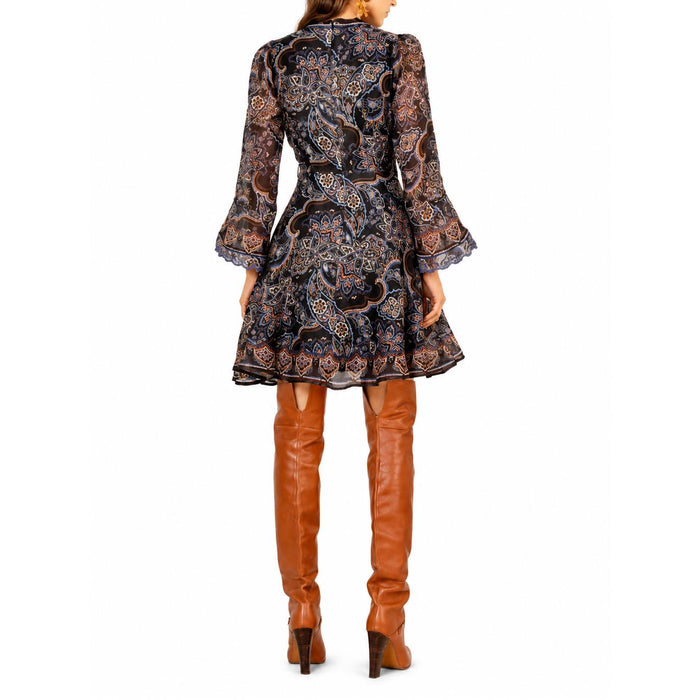 Hale Bob Artemis short dress with 3/4 sleeves, featuring a black paisley print and a tie belt, worn with tan boots.