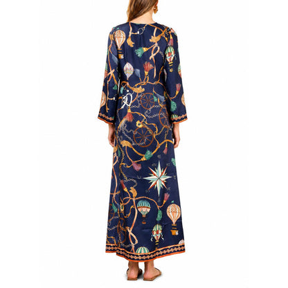 Hale Bob Valery long navy silk dress featuring a nautical print with hot air balloons, gold chains, and compass motifs.