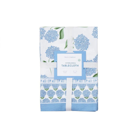 Folded 60x90 cotton tablecloth with blue hydrangea block print pattern and a decorative floral border on a white background.