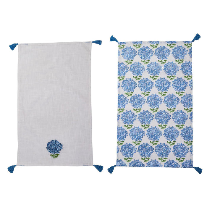 Set of two white cotton dish towels featuring blue hydrangea patterns and decorative corner tassels.
