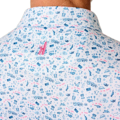 White performance polo with a blue and red patriotic novelty print, featuring a spread collar and moisture-wicking fabric.
