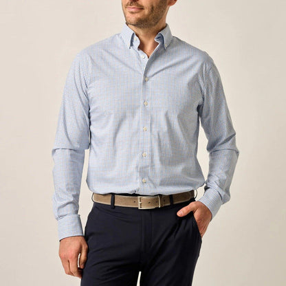 Man wearing a blue and white gingham long-sleeve button-down shirt with a button-down collar and performance fabric.
