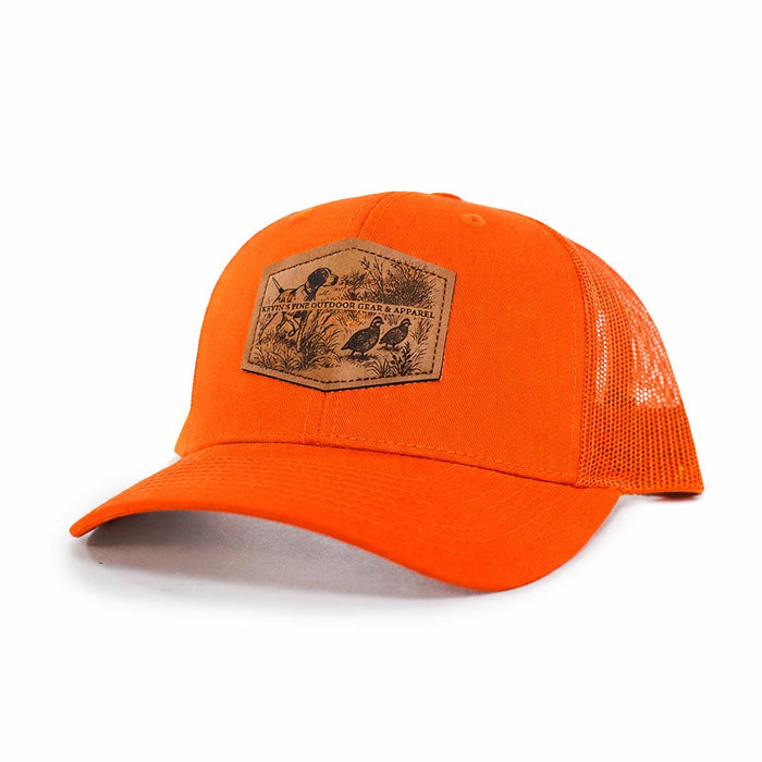 Bright orange Richardson trucker cap featuring a leather patch with an embossed quail and pointer dog scene.