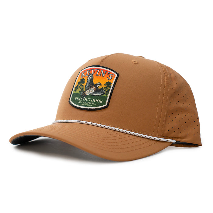 Tan performance rope cap featuring a Kevin's quail sunset patch, laser-perforated side panels, and adjustable snapback.