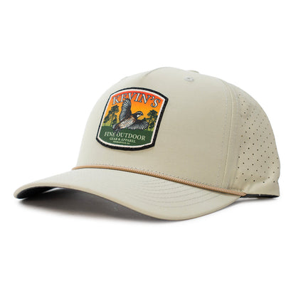 Tan performance rope cap with laser-perforated side panels and a Kevin's Fine Outdoor quail sunset patch.